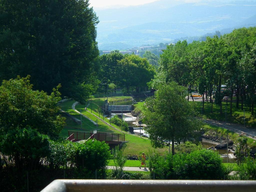 a view of a park with trees and a street at Casa Catharina in La Seu d'Urgell