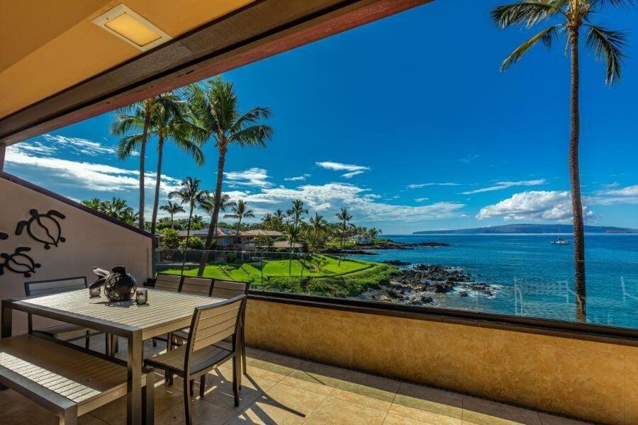 a dining room with a view of the ocean at MAKENA SURF, #G-304 condo in Wailea