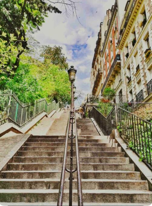 une lumière de rue au-dessus de quelques escaliers dans l'établissement Joli studio- quartier Montmartre, à Paris