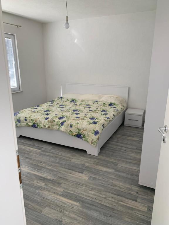 sypialnia z łóżkiem w białym pokoju w obiekcie FetiCozyhome w Prisztinie