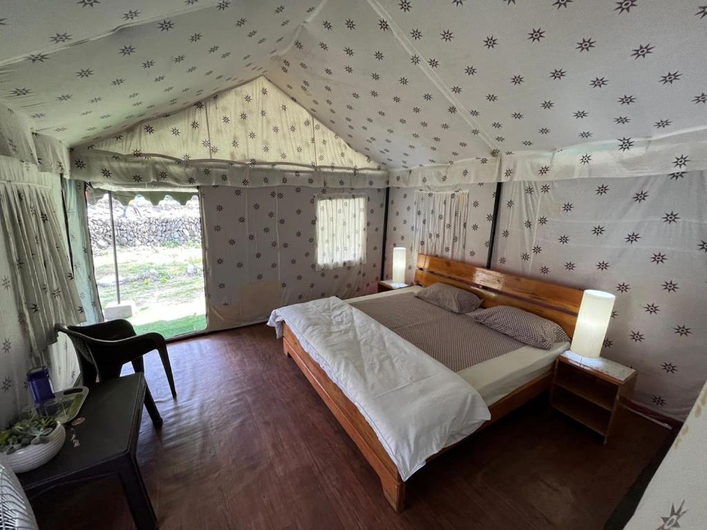 a bedroom with a bed in a tent at Camp Serene in Bhīm Tāl