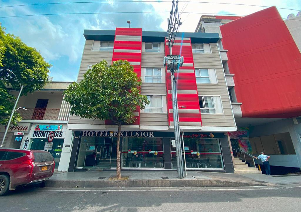 a building with red paint on the side of a street at Hotel Exelsior in Cúcuta