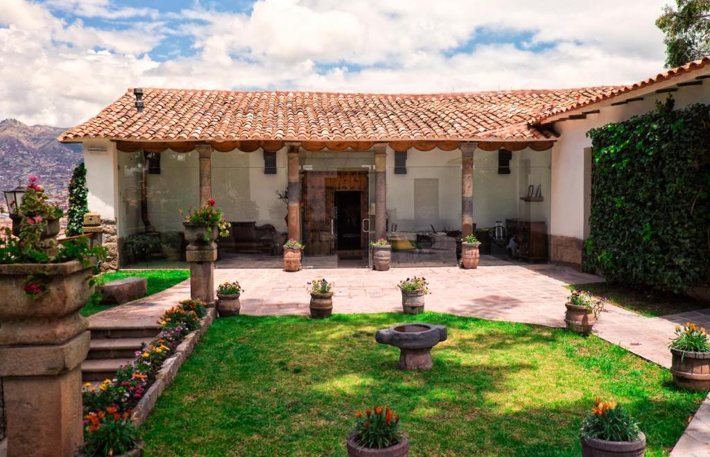 a house with a garden in front of it at Palacio Manco Capac by Ananay Hotels in Cusco