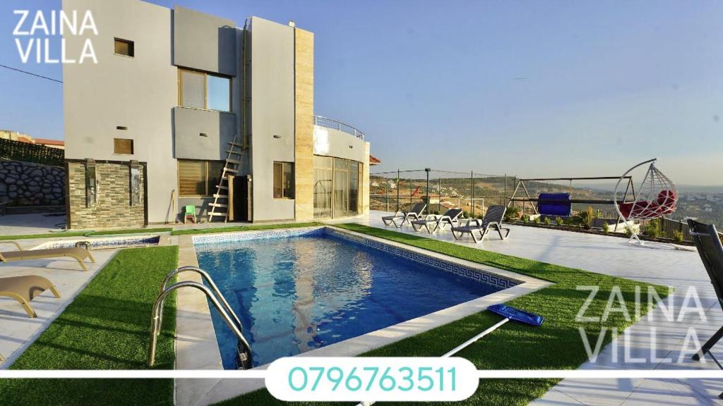 a villa with a swimming pool on top of a building at Zaina Villa in Jerash