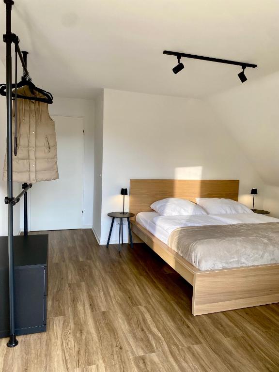 a bedroom with a large bed and wooden floors at Ferienwohnung am Bollrich in Goslar