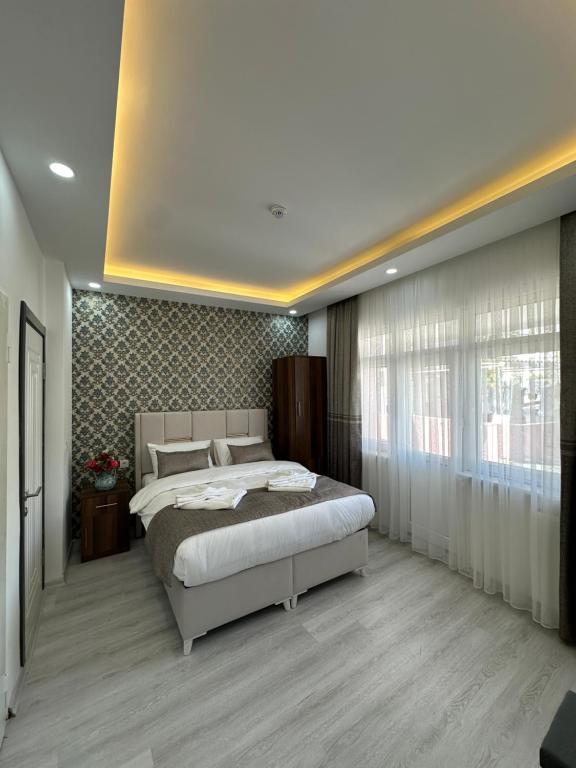 a bedroom with a bed and a large window at Pera Apart in Istanbul