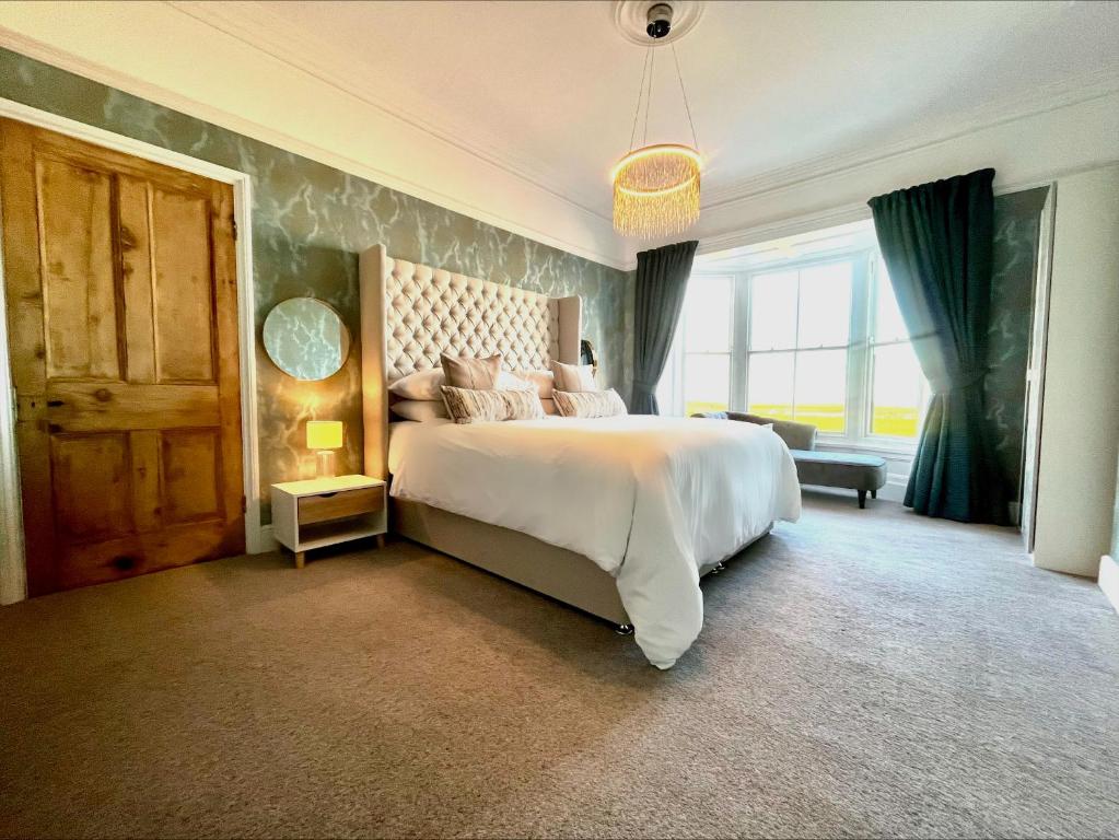 a bedroom with a large bed and a large window at No. 20 The Headland in Hartlepool