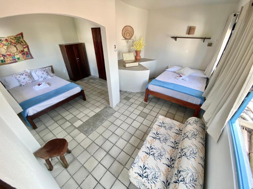 מיטה או מיטות בחדר ב-Pousada Praias do Norte