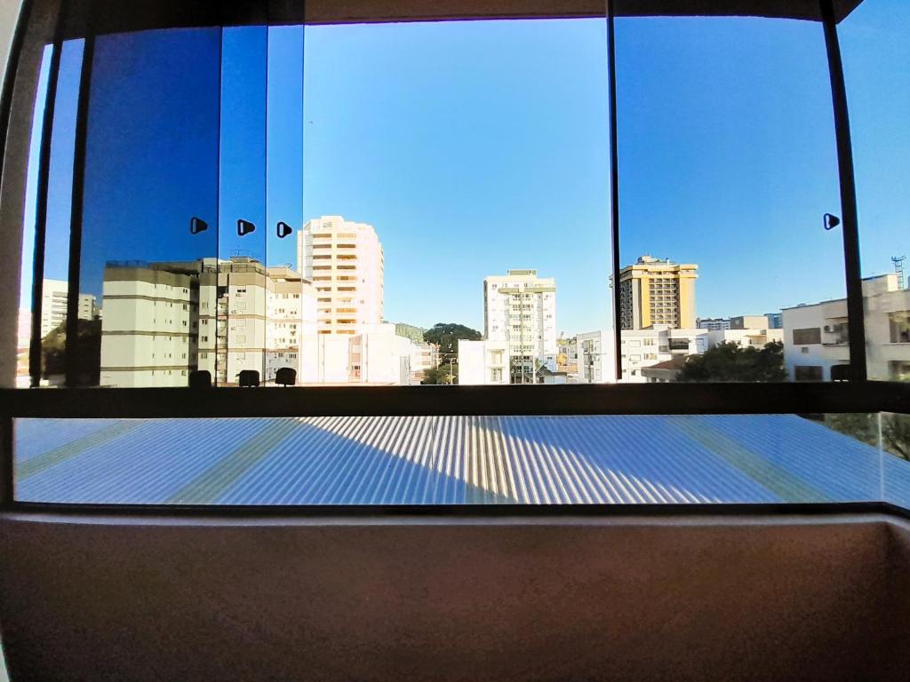 a view of a city skyline from a window at Central APTO Santa Cruz do Sul in Santa Cruz do Sul