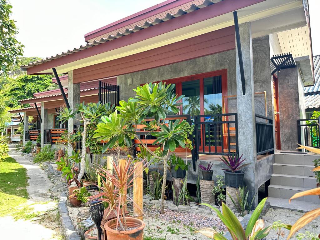 a house with plants in front of it at Ibiza Bungalows in Haad Yao