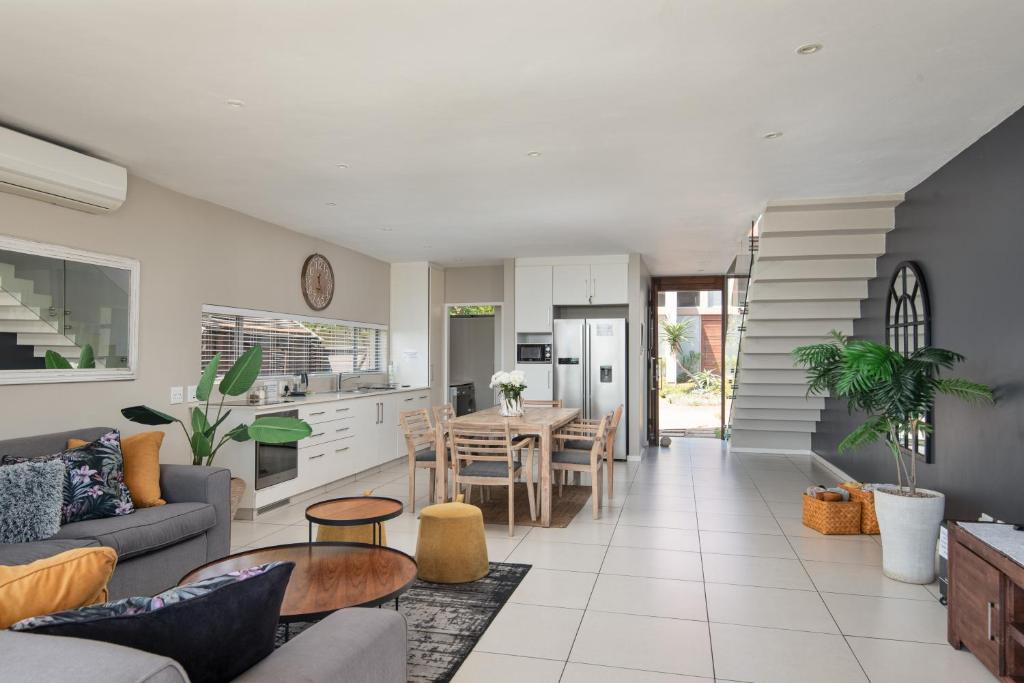 a living room with a couch and a table at 56 Zimbali Wedge in Ballito