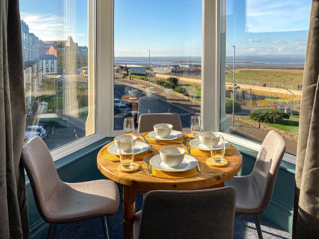 a table in a room with a large window at Blue Sands in Morecambe