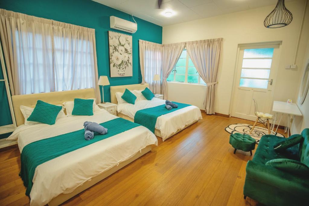 a bedroom with two beds with stuffed animals on them at FA House by the Beach in Tanjung Bungah