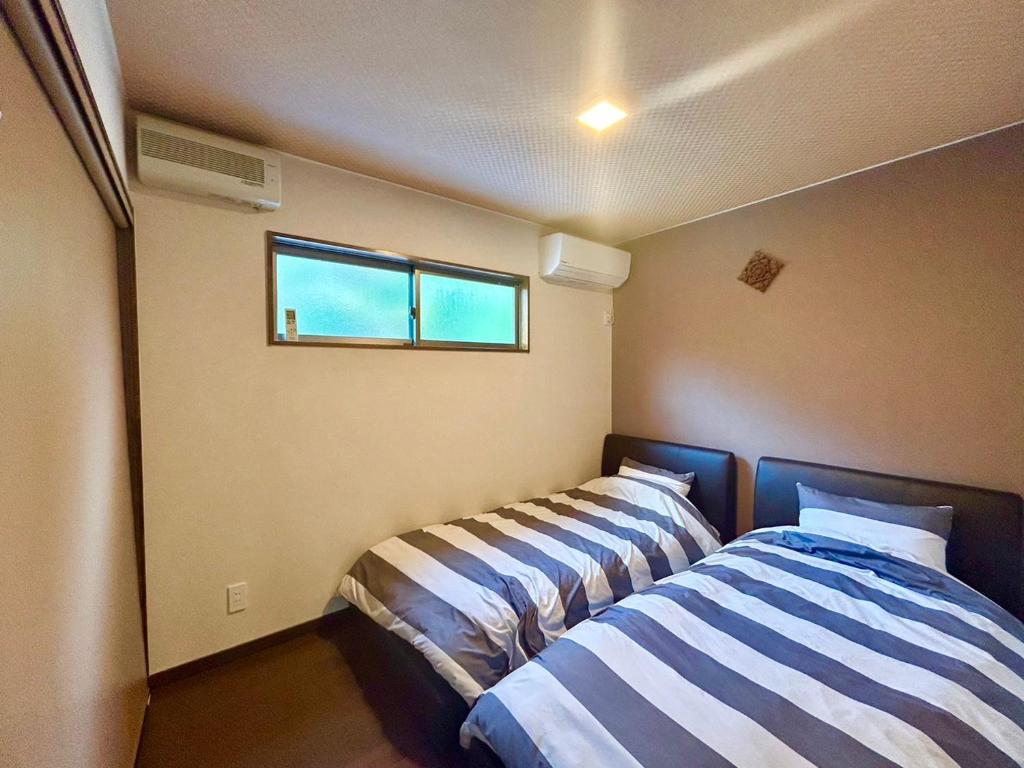 Postel nebo postele na pokoji v ubytování Beach Villa Tachibana