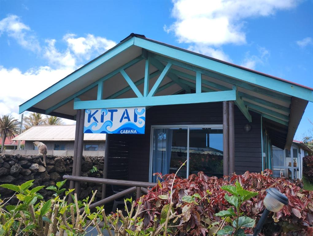 a sign in front of a building at Cabañas Kitai in Hanga Roa