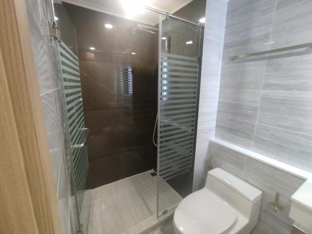 a bathroom with a toilet and a glass shower at 夏威之宿 in Pattaya North
