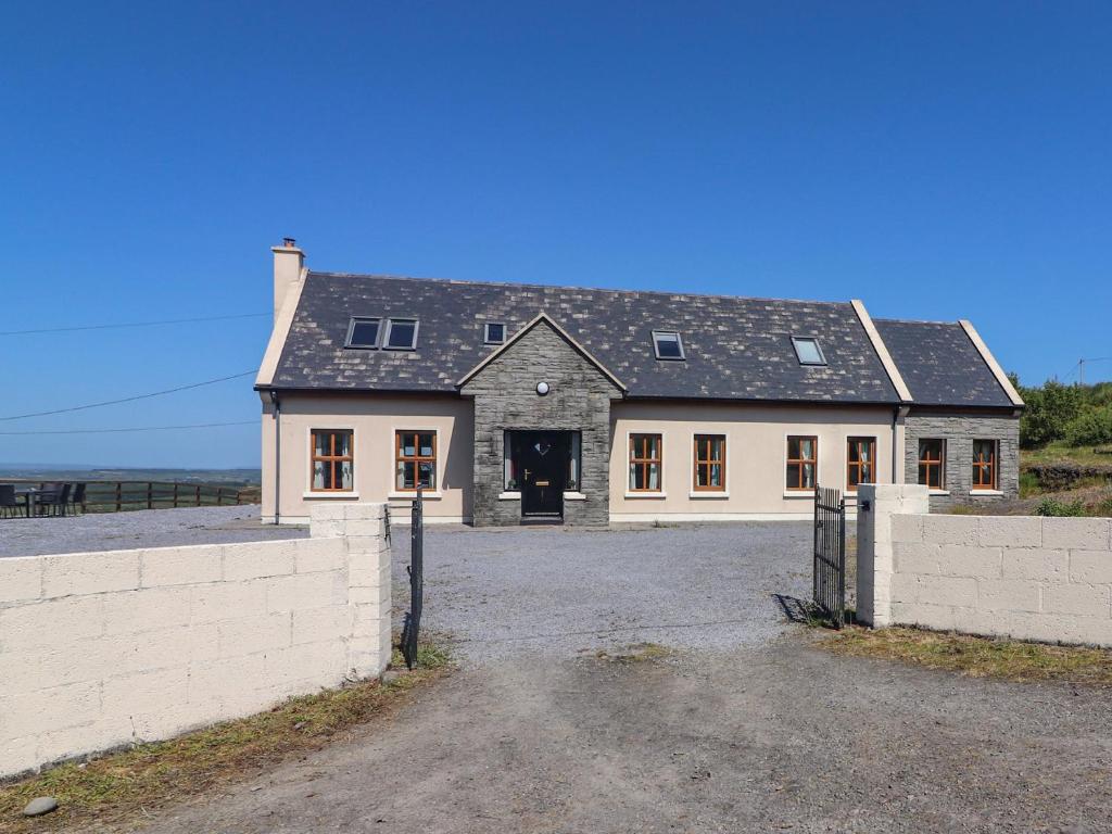 a large white house with a black roof at Lackamore in Lahinch