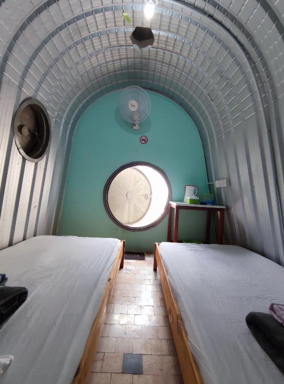 Postel nebo postele na pokoji v ubytování D' Limbai Cottage
