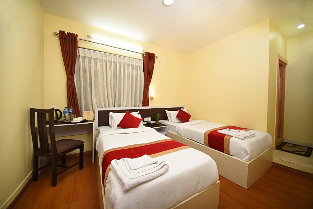Postel nebo postele na pokoji v ubytování Hotel Odyssey Nepal