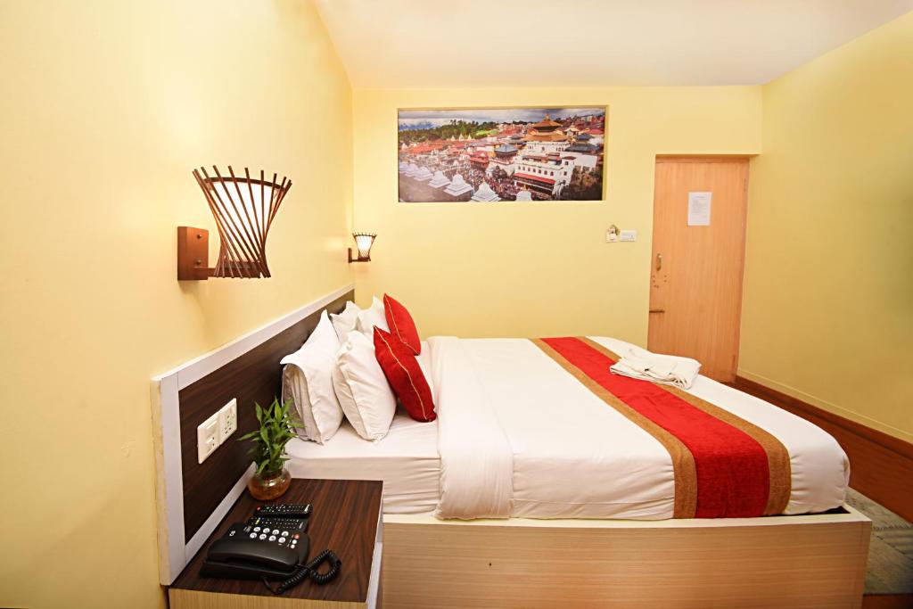 Postel nebo postele na pokoji v ubytování Hotel Odyssey Nepal