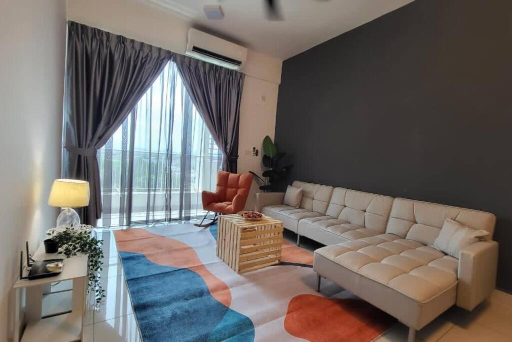 a living room with a couch and a large window at Stay@12 D'Festivo Residence Ipoh Perak in Ipoh
