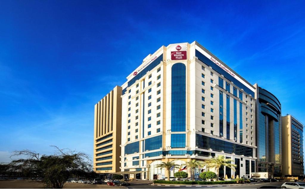 a large white building with a lot of windows at Best Western Plus Doha in Doha