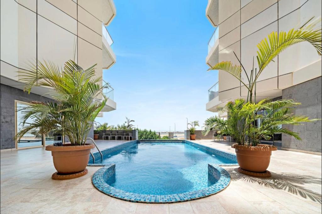 a swimming pool in the middle of a building with plants at Obhur Residence 2 in Obhor