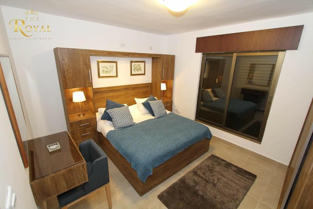 a bedroom with a bed and a large mirror at Royal Luxury Apartments & Studios 2 in Amman