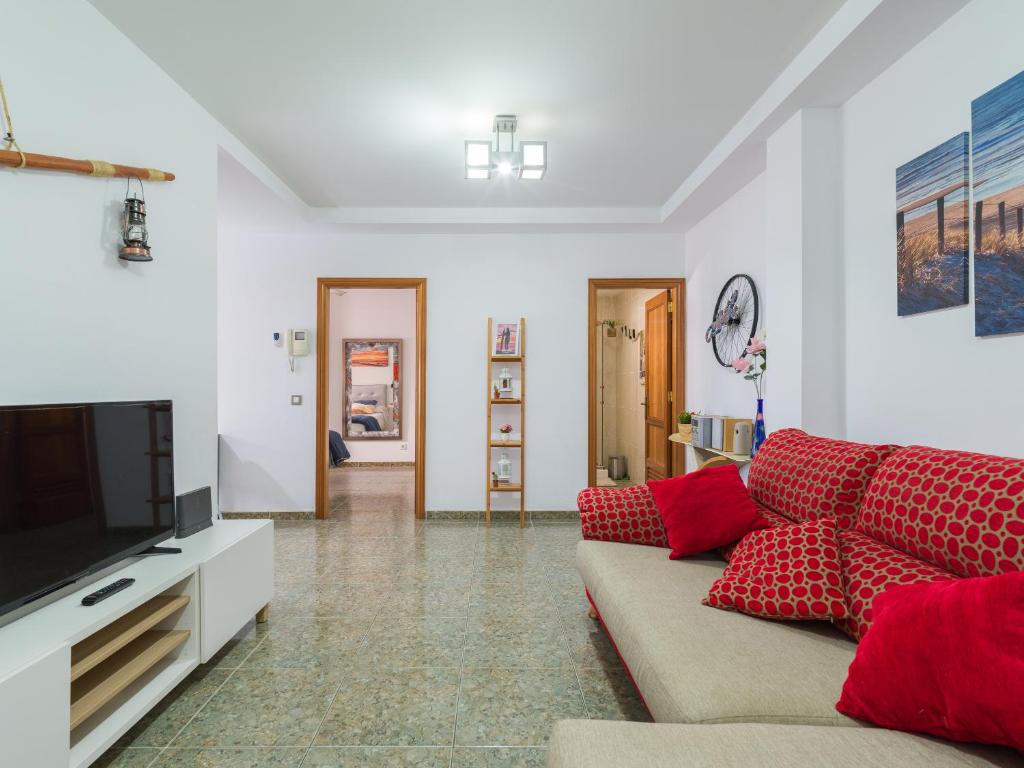 a living room with a couch and a television at Bluebeach in Las Palmas de Gran Canaria