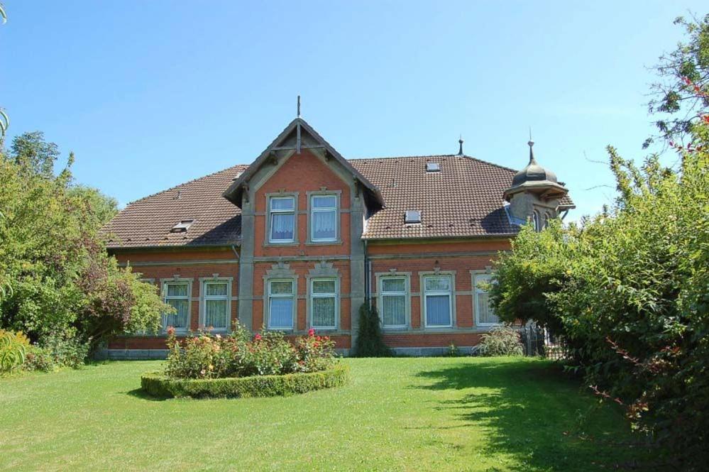 a large house with a large yard with a garden at Hof Kröger Ferienwohnung Nr 03 in Travemünde