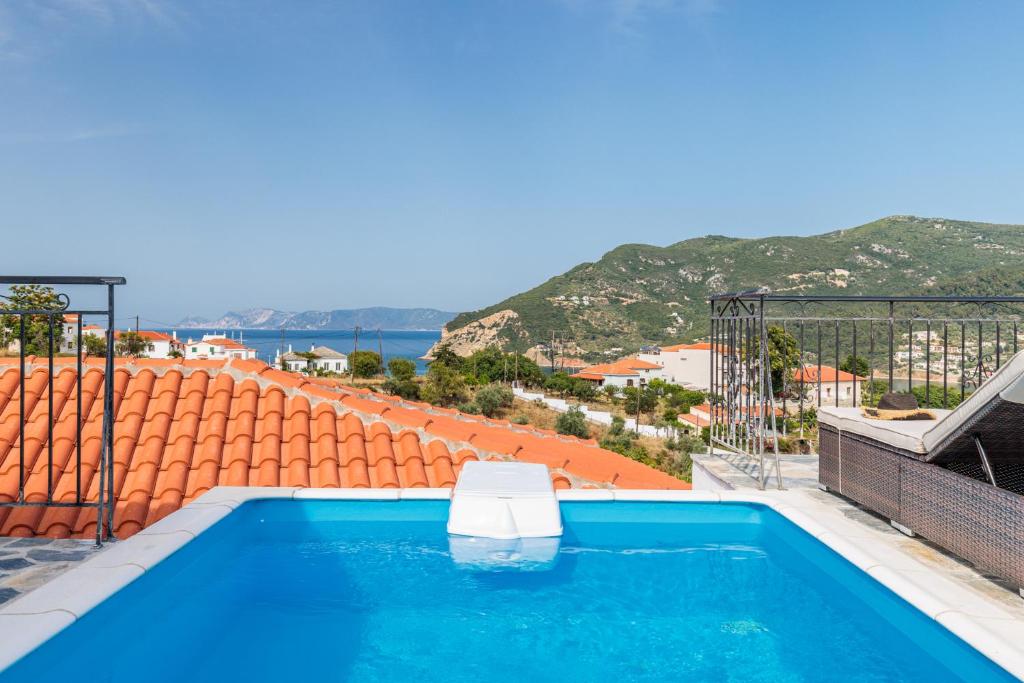 a swimming pool on the roof of a house with a view at Aloupi Pool Apartment in Skopelos Town