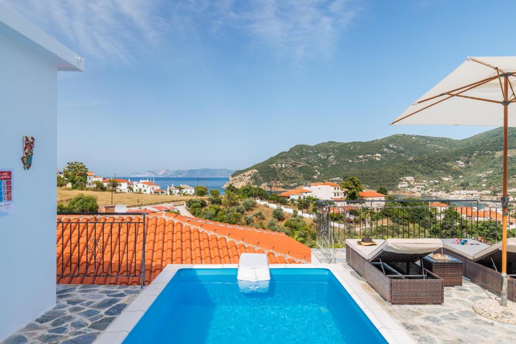 a swimming pool with a view of a city at Aloupi Pool Apartment in Skopelos Town