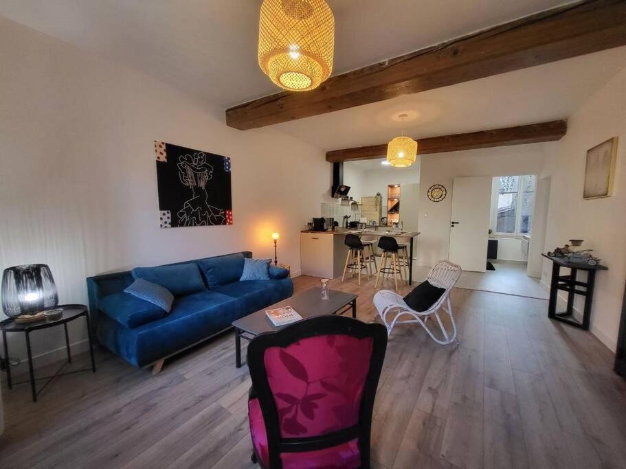 sala de estar con sofá azul y mesa en Ô Bon'Endroit - Appartement Confort - Centre Ville, en Vienne