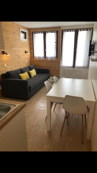 un salon avec une table et un canapé dans l'établissement Appartement cosy val louron au pied des pistes, à Val Louron