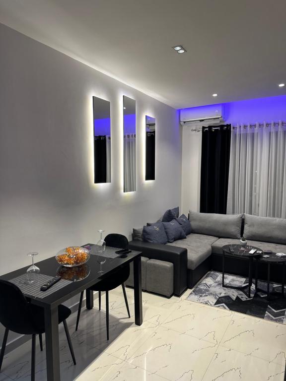 uma sala de estar com um sofá e uma mesa em Sueño Apartments & Suites em Tirana