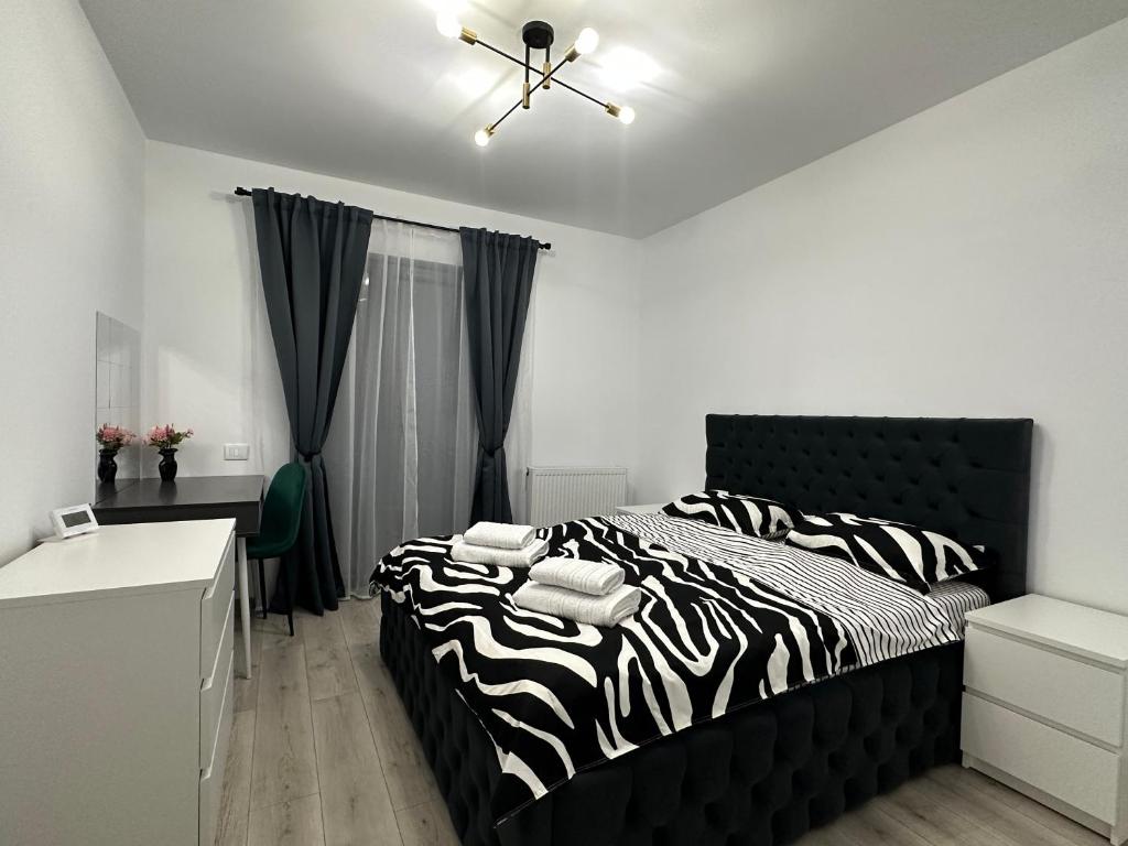 a bedroom with a zebra print bed and a desk at LoSt Studio in Cristian