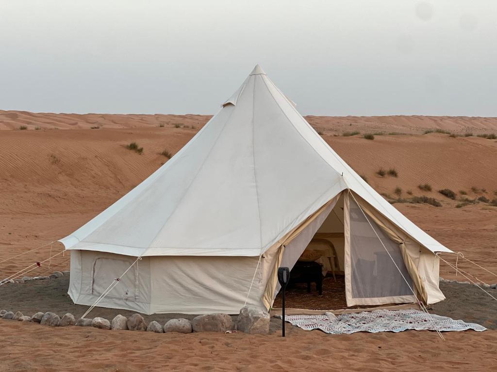 BadīyahにあるThousand Stars Desert Campの砂漠の真ん中の白いテント