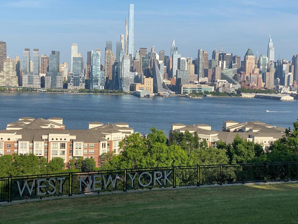a view of the west new york city from a park at Lovely Cozy apt West NY NJ Excellent transportation 12 minutes to NY 7 minutes at NYWater Way Ferry in West New York