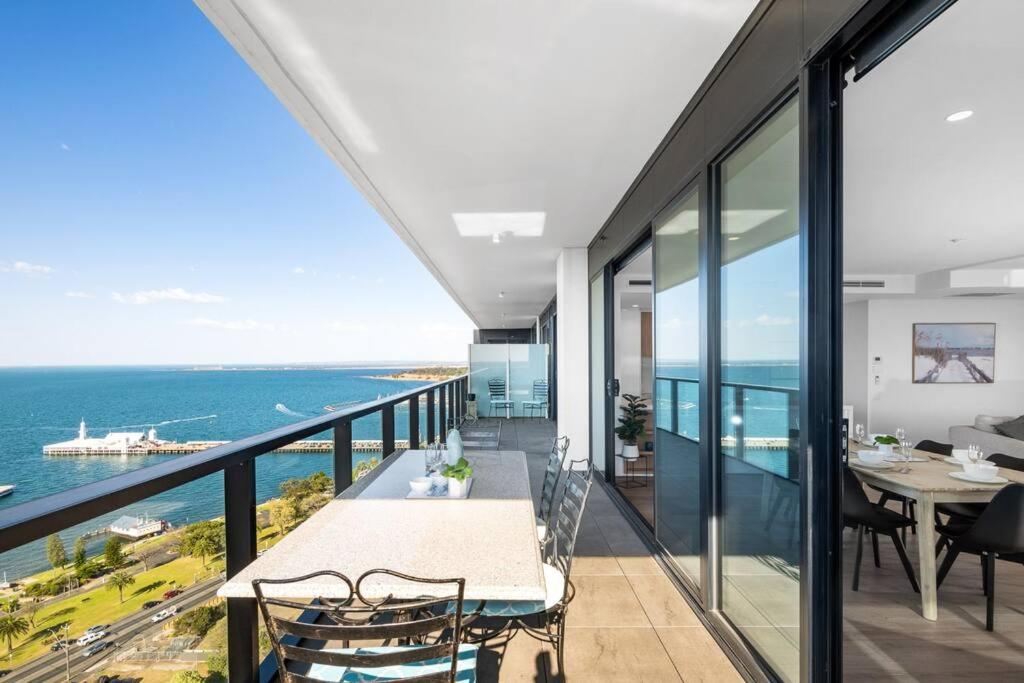a view of the ocean from the balcony of a house at Modern, Spacious 2BR Penthouse with Bay Views in Geelong