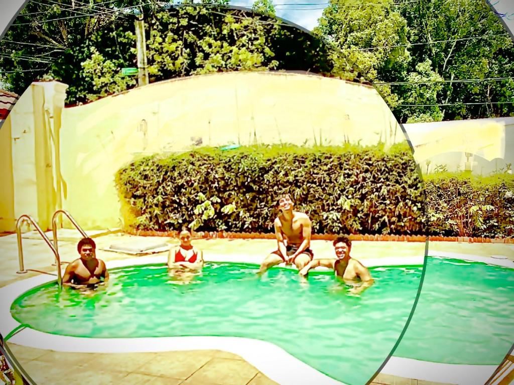 a group of men sitting in a swimming pool at 1Dom Rep - Huge cozy 3 bedrooms - Electric transformer and Inverter- close to all transportation Jacobo Majluta - Residencial Paradise V Colina Arroyo 1 in Santo Domingo