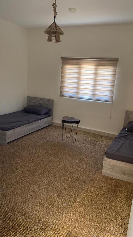 Voodi või voodid majutusasutuse Wadi Al-Nakhil Hostel toas