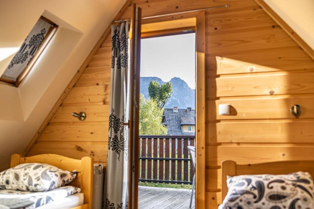 a bedroom with a door leading to a balcony at Apartamenty i pokoje gościnne Wajdówka in Zakopane