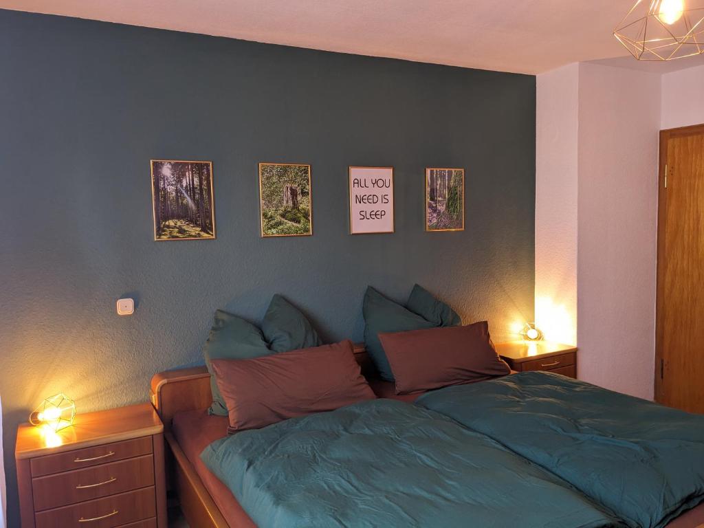 a bedroom with a bed with two lights on at WaldHausen, kostenfrei WLAN und Netflix in Momlingen