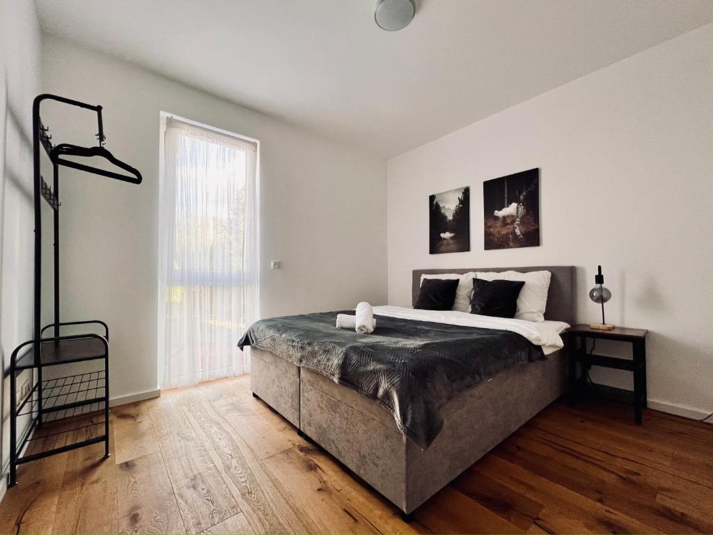 ein weißes Schlafzimmer mit einem großen Bett und einem Fenster in der Unterkunft Elegantes Refugium in Düren in Düren - Eifel
