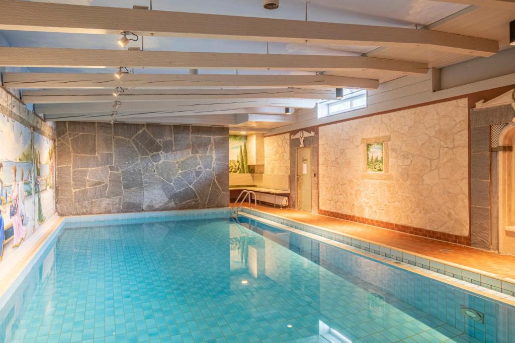 einen Pool in einem Gebäude mit Pool in der Unterkunft Hotel am Schlosspark Zum Kurfürst in Oberschleißheim