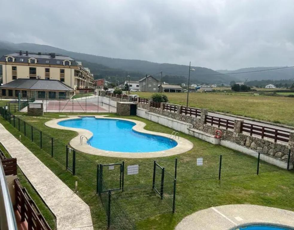 a swimming pool in the middle of a field at PLAYASDEBARREIROs in San Miguel de Reinante