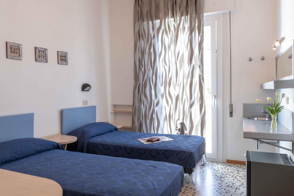 Postel nebo postele na pokoji v ubytování Hotel Smart Cervia B&B