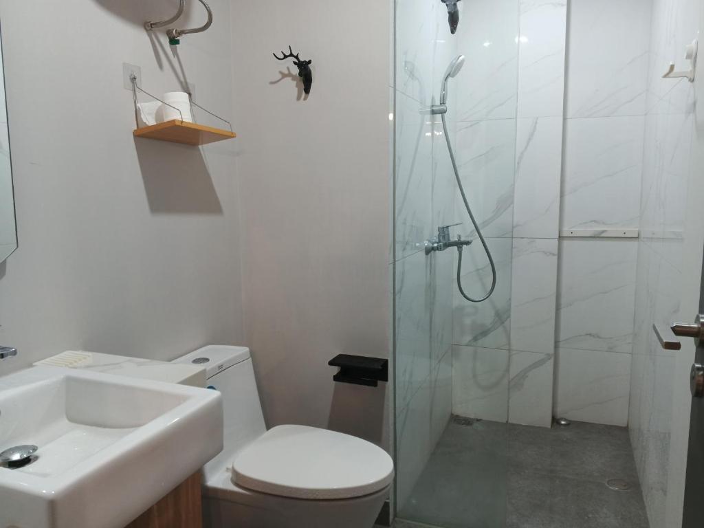 a bathroom with a shower and a toilet and a sink at Peaceful Sea view Cozy APT at Batam Center - By MESA in Batam Center