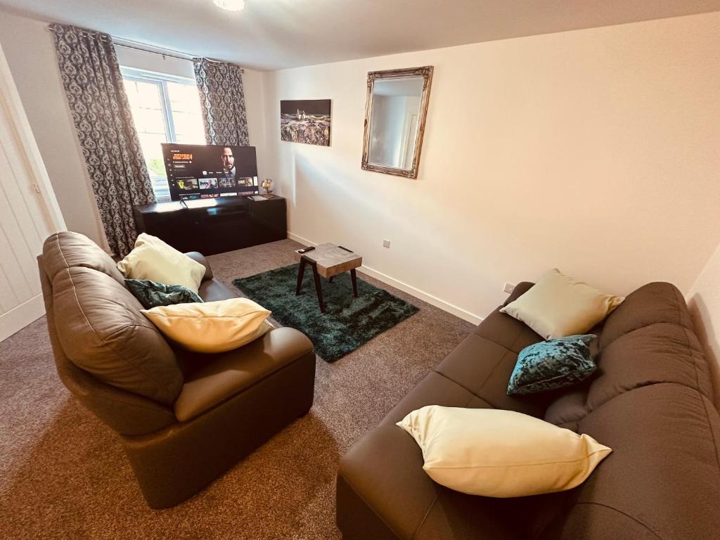 a living room with a couch and a chair at Newhaven House in Liverpool