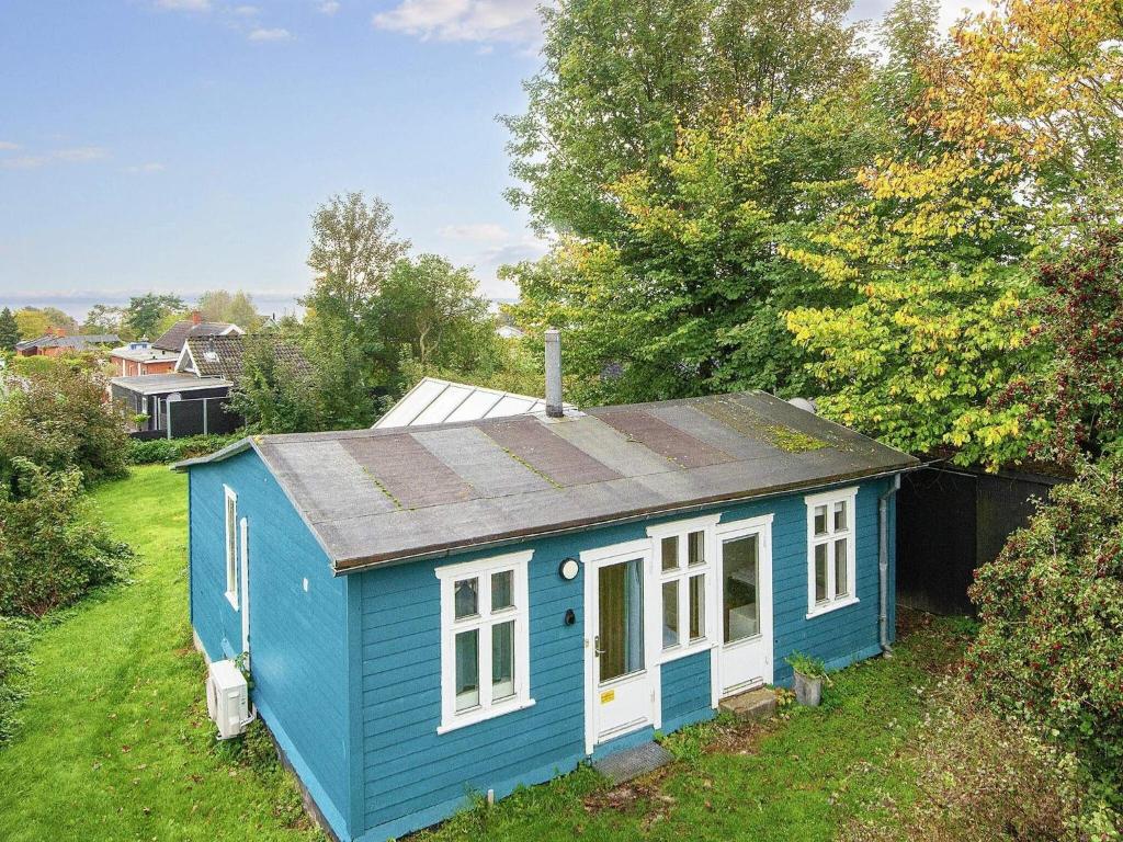 a blue tiny house in a yard at Holiday home Egå III in Egå